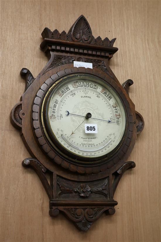 A late Victorian carved oak barometer W.35cm